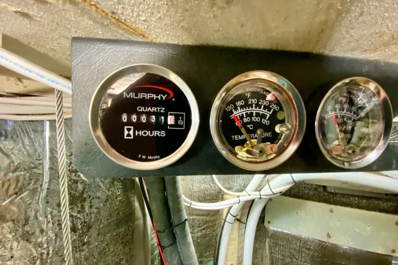 Slide: The Image of Engine gauges on a 1980 Wellington 44, displaying hours, temperature, and pressure. - 41