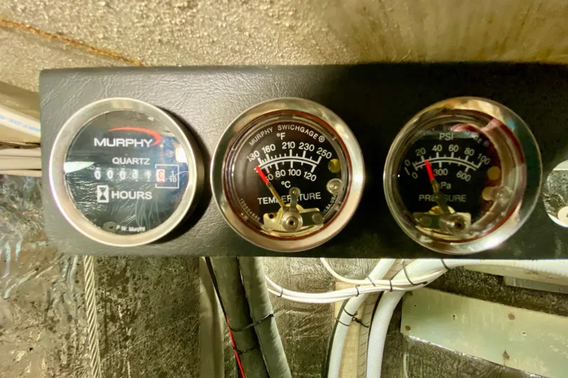 Slide: The Image of Vintage Wellington 44 engine gauges from 1980, displaying hours, temperature, and pressure readings. - 42