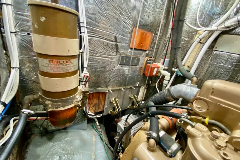 Slide: The Image of Engine room of 1980 Wellington 44 with Racor fuel filter and various mechanical components. - 44