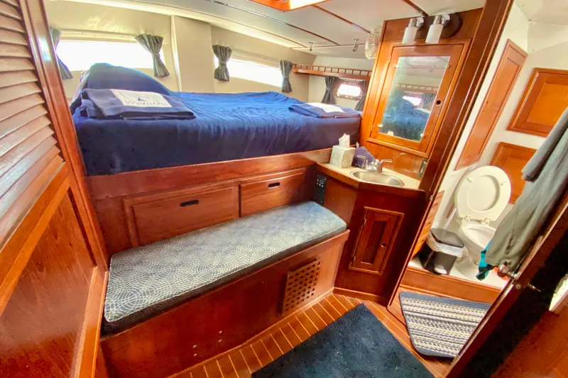 Slide: The Image of Cozy 1980 Wellington 44 yacht cabin with bed, sink, and toilet. - 49