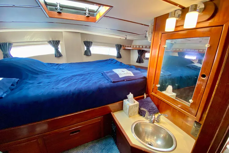 Slide: The Image of Cozy 1980 Wellington 44 yacht cabin with bed, sink, and mirror. - 52