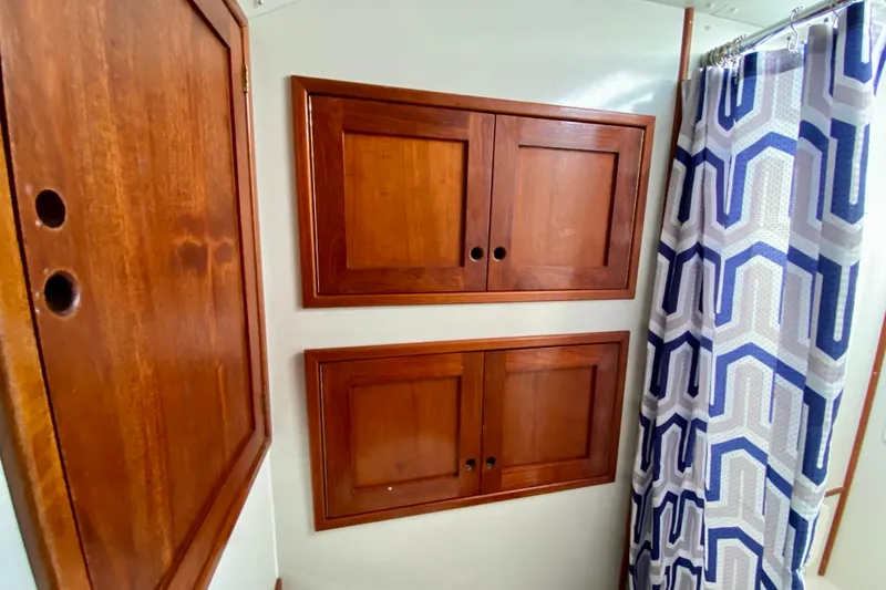 Slide: The Image of Wooden cabinets and geometric shower curtain in 1980 Wellington 44 interior. - 58