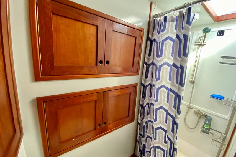 Slide: The Image of Wooden cabinets and geometric shower curtain in 1980 Wellington 44 bathroom. - 59