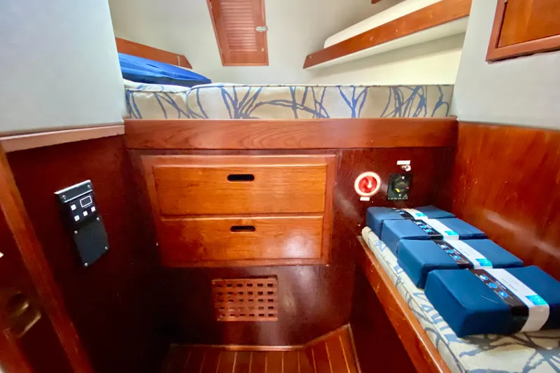 Slide: The Image of Cozy cabin interior of 1980 Wellington 44 yacht with wooden drawers and bedding. - 65