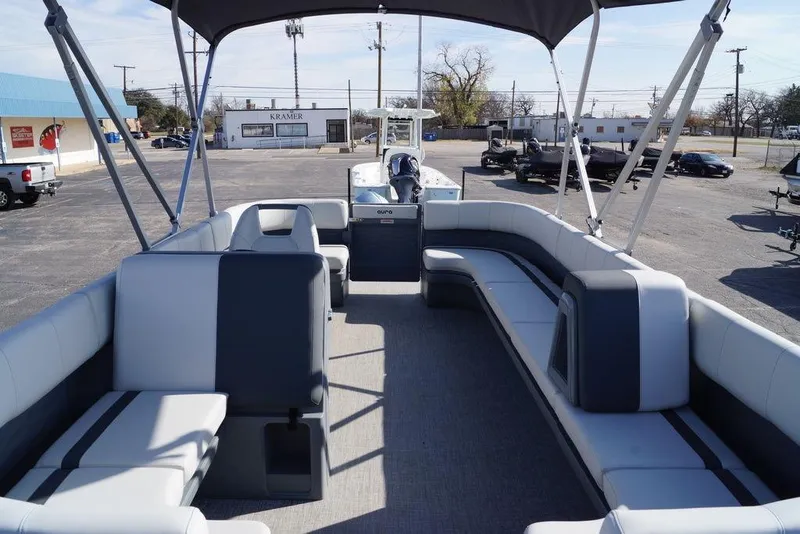 Slide: The Image of 2026 Avalon GS Quad Lounge 18' pontoon boat with spacious seating and canopy in a parking lot. - 10