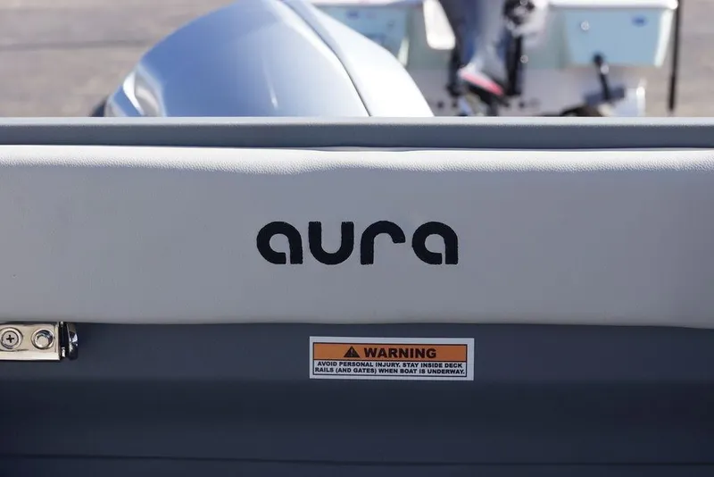 Slide: The Image of 2026 Avalon GS Quad Lounge boat with "aura" logo and safety warning label. - 16