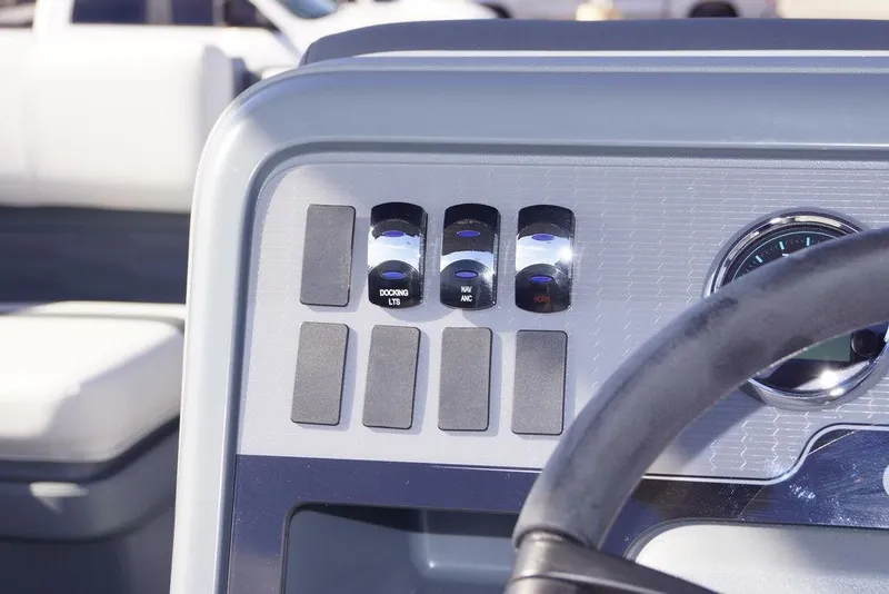 Slide: The Image of Control panel of 2026 Avalon GS Quad Lounge boat with switches and steering wheel. - 17