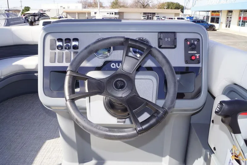 Slide: The Image of Steering console of 2026 Avalon GS Quad Lounge 18' pontoon boat with modern controls. - 19