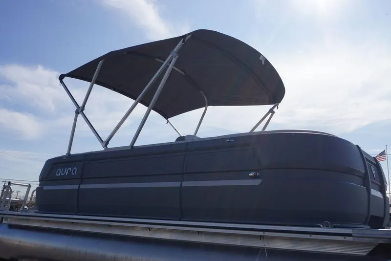 Slide: The Image of 2026 Avalon GS Quad Lounge pontoon boat with canopy under a clear sky. - 7