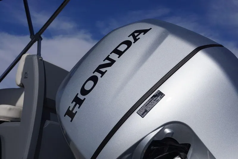 Slide: The Image of Silver Honda outboard motor on 2026 Avalon GS Quad Lounge boat under blue sky. - 8