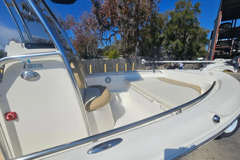 Slide: The Image of 2017 Key West 189 FS boat interior with seating and railing, under clear blue sky. - 11
