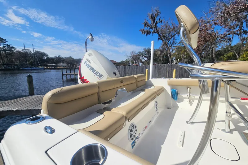 Slide: The Image of 2017 Key West 189 FS boat interior with Evinrude engine, docked by a scenic waterfront. - 13