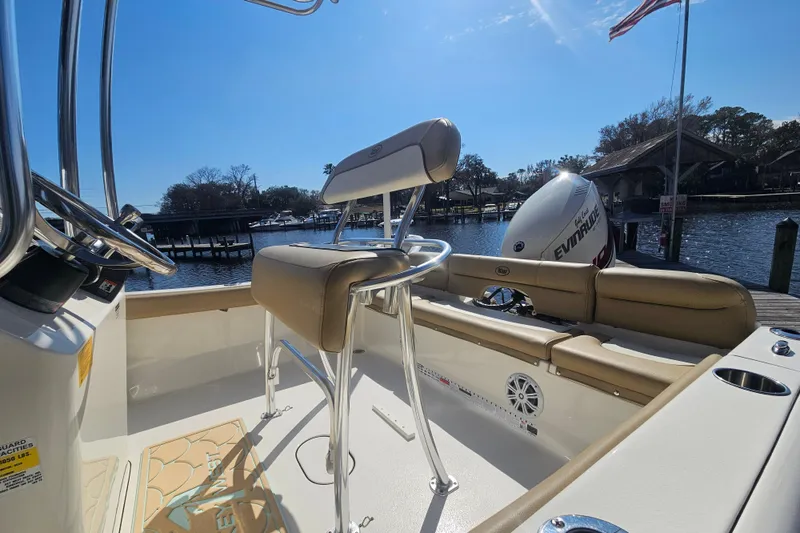 Slide: The Image of 2017 Key West 189 FS boat interior with seating and Evinrude engine by the dock. - 14