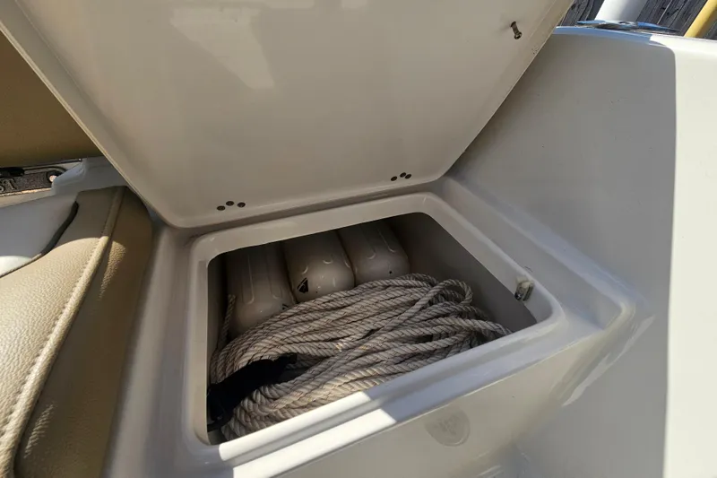 Slide: The Image of Open storage compartment in 2017 Key West 189 FS boat with coiled rope inside. - 16