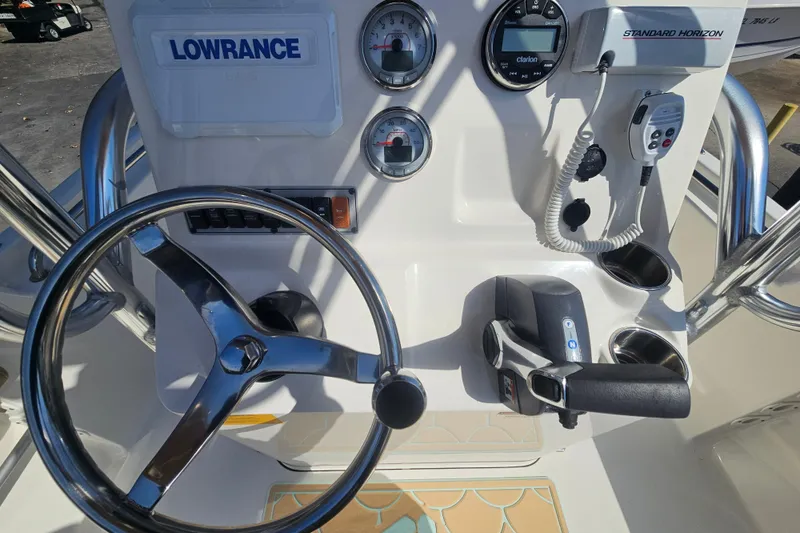 Slide: The Image of 2017 Key West 189 FS boat dashboard with steering wheel and navigation controls. - 19