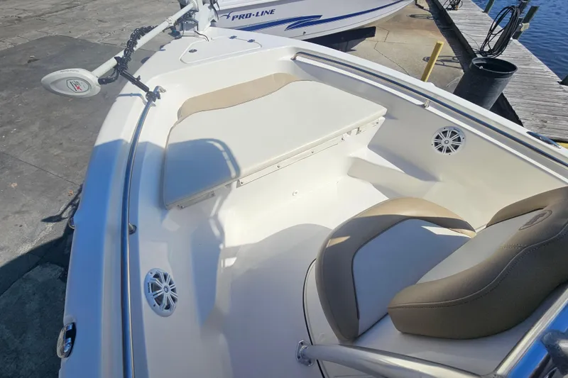 Slide: The Image of 2017 Key West 189 FS boat interior with seating and speakers at dockside. - 20