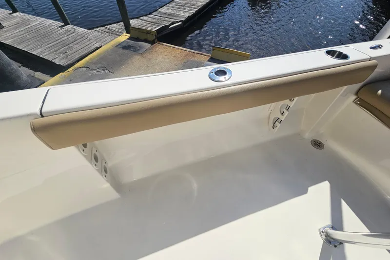 Slide: The Image of 2017 Key West 189 FS boat interior with beige seating and cup holder by the dock. - 27