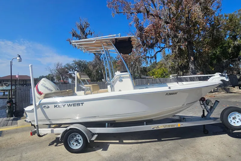 Slide: The Image of 2017 Key West 189 FS boat on trailer, parked outdoors under clear sky. - 7