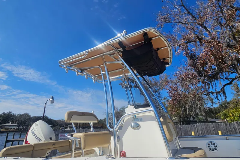 Slide: The Image of 2017 Key West 189 FS boat with canopy, parked by a scenic riverside. - 8