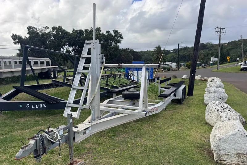 Slide: The Image of Trailer for 2020 World Cat 320 CC boat parked on grassy roadside. - 6