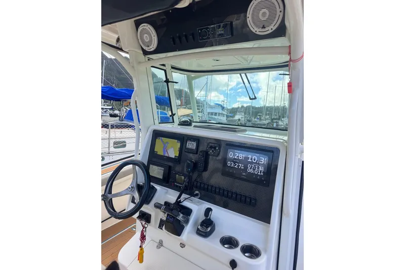 Slide: The Image of 2020 World Cat 320 CC boat dashboard with navigation and control systems. - 7
