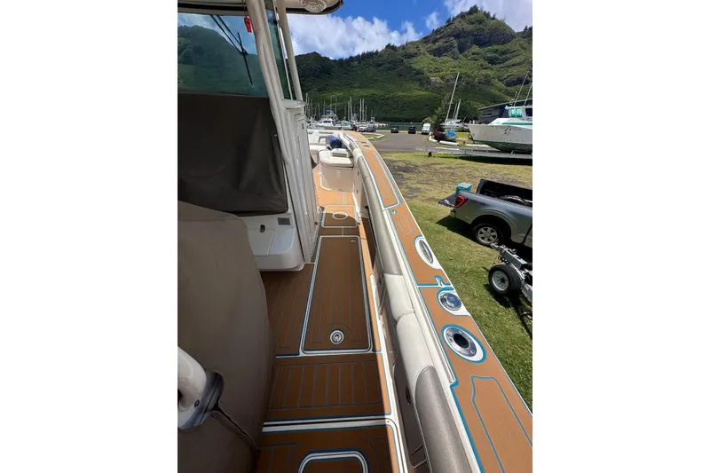 Slide: The Image of 2020 World Cat 320 CC boat deck with scenic mountain backdrop. - 9