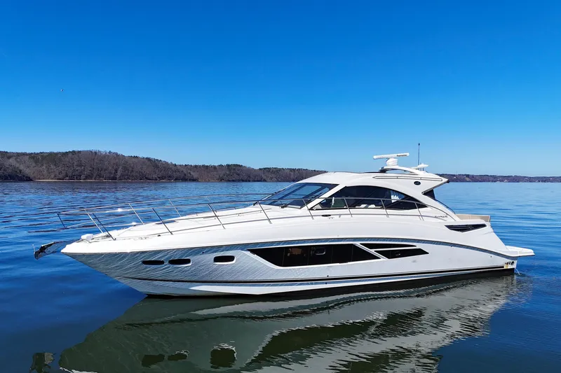 The Image of 2016 Sea Ray Sundancer 510 yacht on calm water under clear blue sky. - 0
