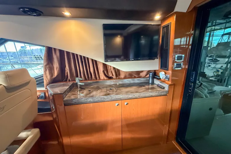 Slide: The Image of Luxurious interior of 2016 Sea Ray Sundancer 510 yacht with TV and kitchenette. - 13