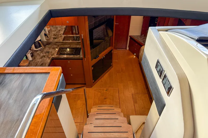 Slide: The Image of Interior view of 2016 Sea Ray Sundancer 510 yacht, featuring a modern kitchen and wooden flooring. - 18