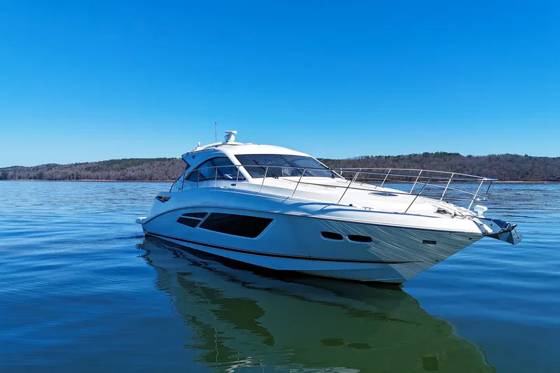 Slide: The Image of 2016 Sea Ray Sundancer 510 yacht on calm water under clear blue sky. - 2