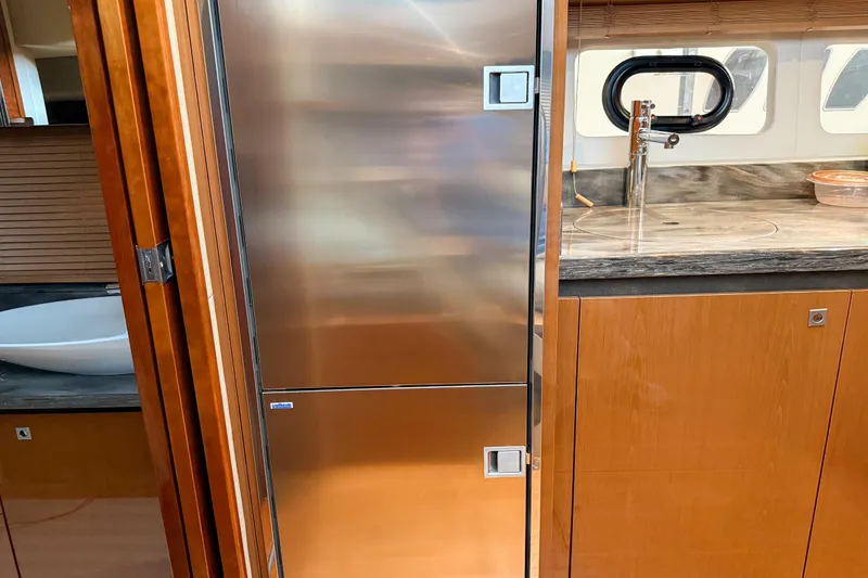 Slide: The Image of Interior of 2016 Sea Ray Sundancer 510 yacht with modern kitchen amenities. - 21