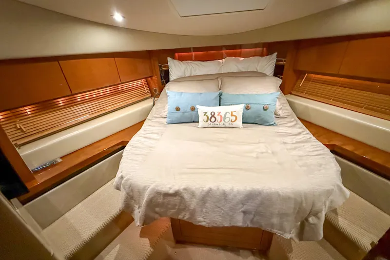 Slide: The Image of Luxurious 2016 Sea Ray Sundancer 510 yacht bedroom with cozy bedding and elegant wood accents. - 26