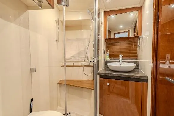 Slide: The Image of Luxurious bathroom in 2016 Sea Ray Sundancer 510 yacht with modern fixtures and wood accents. - 38