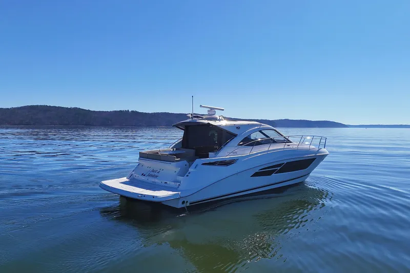 Slide: The Image of 2016 Sea Ray Sundancer 510 yacht cruising on calm waters under clear blue sky. - 4