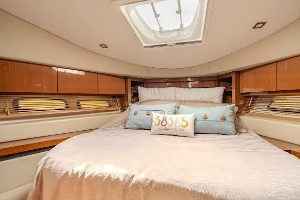 Slide: The Image of Luxurious bedroom interior of 2016 Sea Ray Sundancer 510 yacht with skylight and elegant bedding. - 40