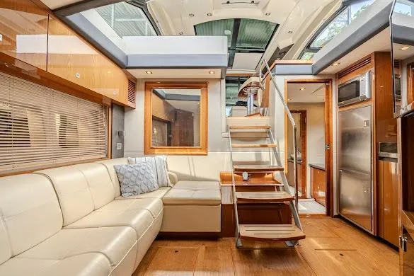 Slide: The Image of Luxurious interior of 2016 Sea Ray Sundancer 510 yacht with modern furnishings and wooden accents. - 45