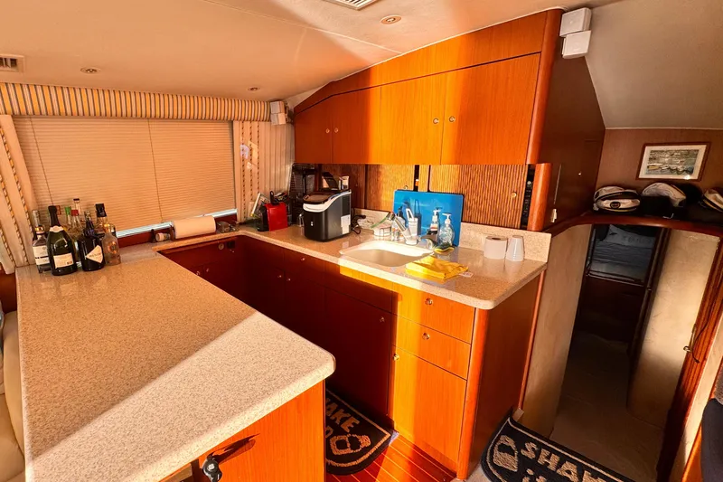 Slide: The Image of Luxurious 1999 Ocean Yachts 48 Super Sport interior with modern kitchen amenities. - 10