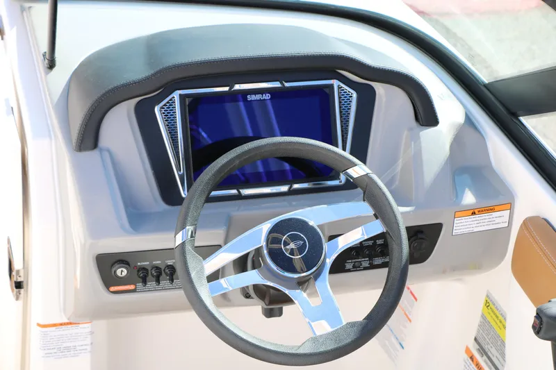 Slide: The Image of 2026 Chaparral 21 SSi Ski & Fish boat dashboard with steering wheel and Simrad display. - 15