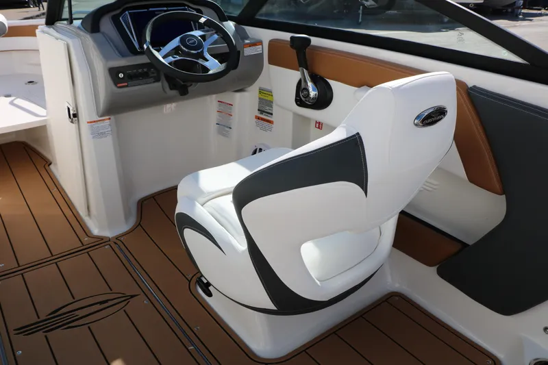 Slide: The Image of 2026 Chaparral 21 SSi Ski & Fish boat interior with captain's chair and control panel. - 24
