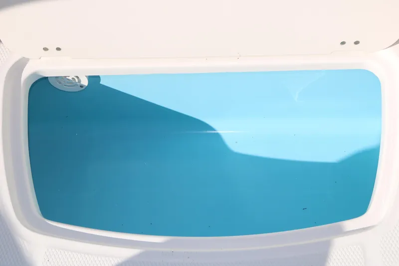 Slide: The Image of Livewell compartment in 2026 Chaparral 21 SSi Ski & Fish boat, featuring a clean blue interior. - 25