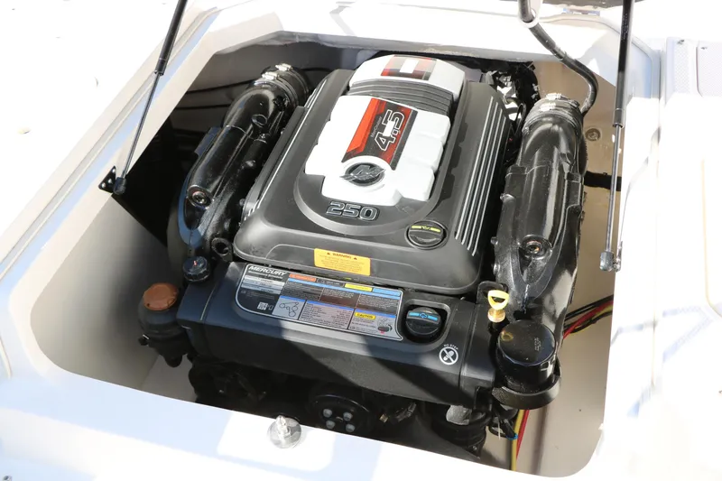 Slide: The Image of 2026 Chaparral 21 SSi Ski & Fish boat engine compartment, featuring a powerful 250 HP engine. - 26