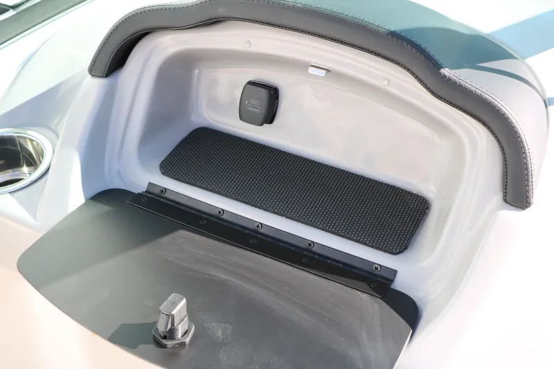 Slide: The Image of 2026 Chaparral 21 SSi Ski & Fish boat storage compartment with cup holder. - 29