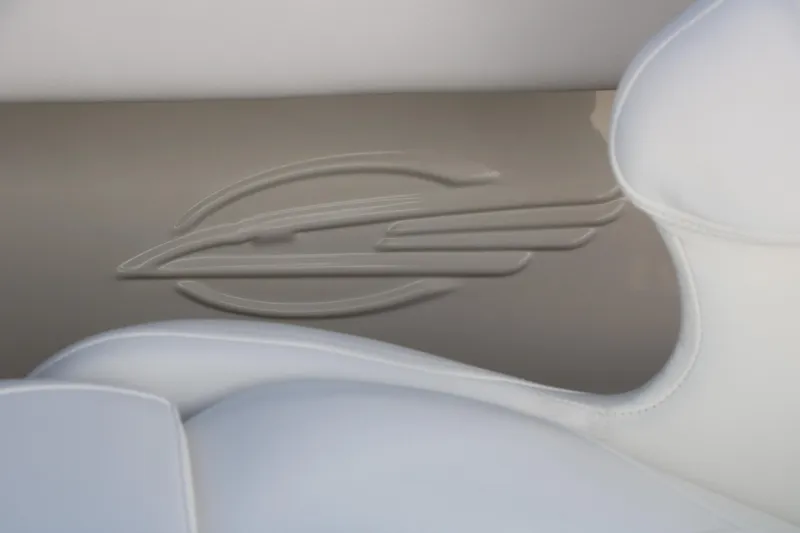 Slide: The Image of 2026 Chaparral 21 SSi Ski & Fish interior detail with embossed logo and white upholstery. - 42