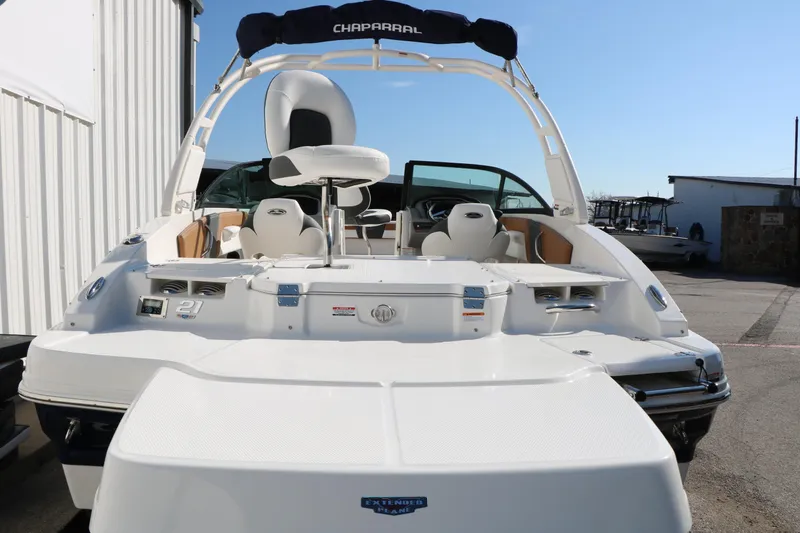 Slide: The Image of 2026 Chaparral 21 SSi Ski & Fish boat, rear view, white exterior, docked outdoors. - 6