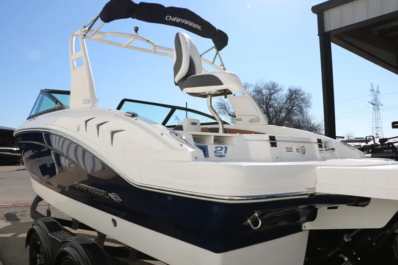 Slide: The Image of 2026 Chaparral 21 SSi Ski & Fish boat, sleek design, parked outdoors. - 7