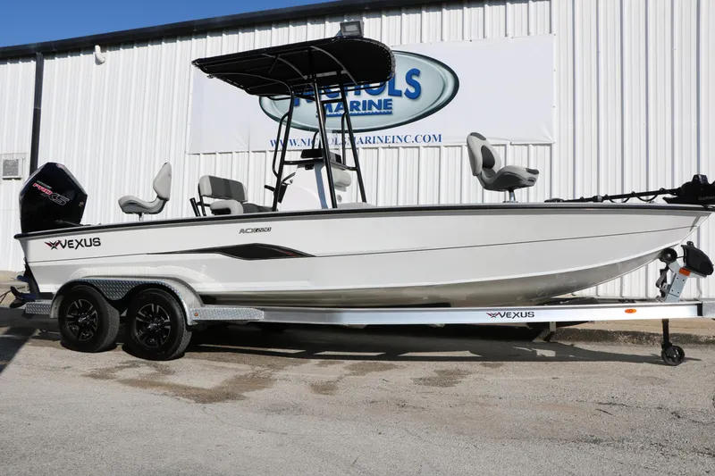 The Image of 2025 Vexus ACX 2210 boat on trailer, parked outside a marine dealership. - 1