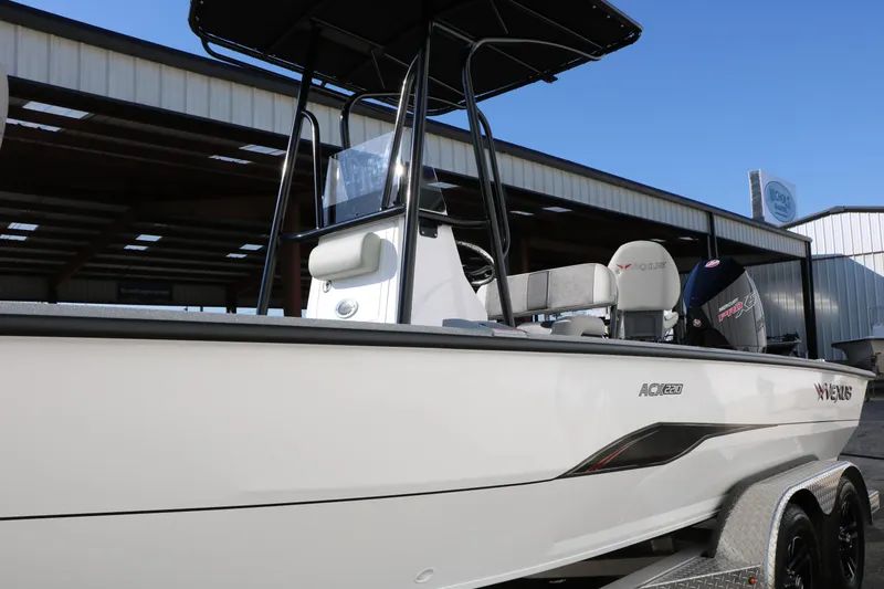 Slide: The Image of 2025 Vexus ACX 2210 boat with sleek design, parked in a covered area. - 10