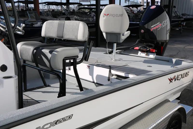Slide: The Image of 2025 Vexus ACX 2210 boat interior with seating and Mercury Pro XS engine. - 11