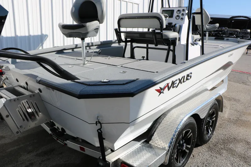 Slide: The Image of 2025 Vexus ACX 2210 boat on trailer, featuring sleek design and modern seating. - 14