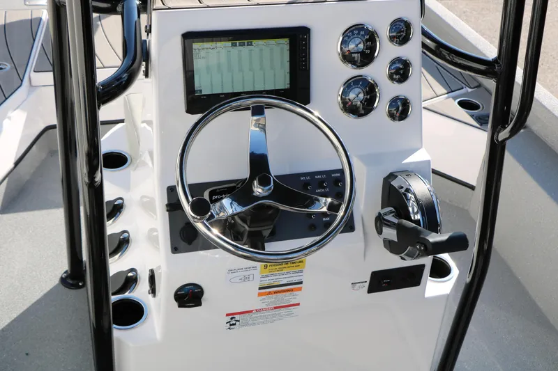 Slide: The Image of 2025 Vexus ACX 2210 boat dashboard with steering wheel and control panel. - 26
